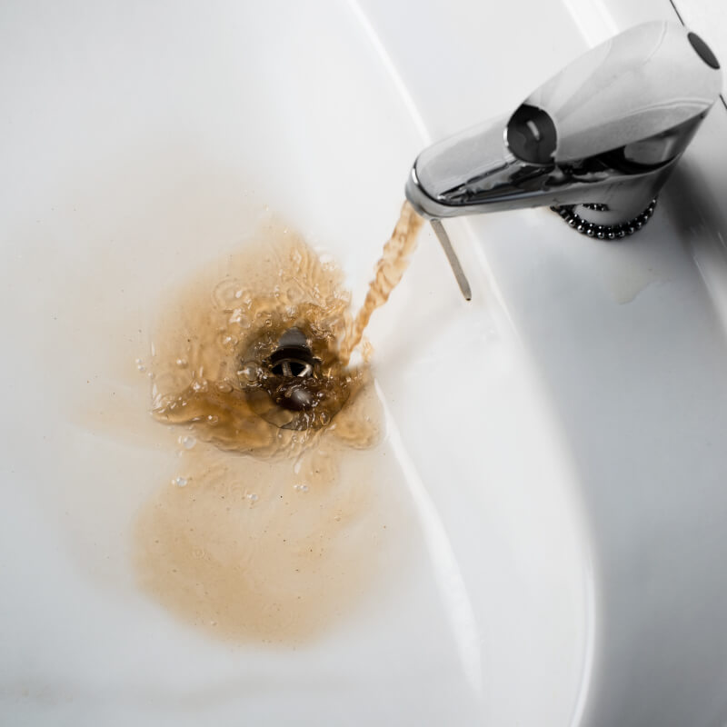 dirty water coming out of a silver faucet